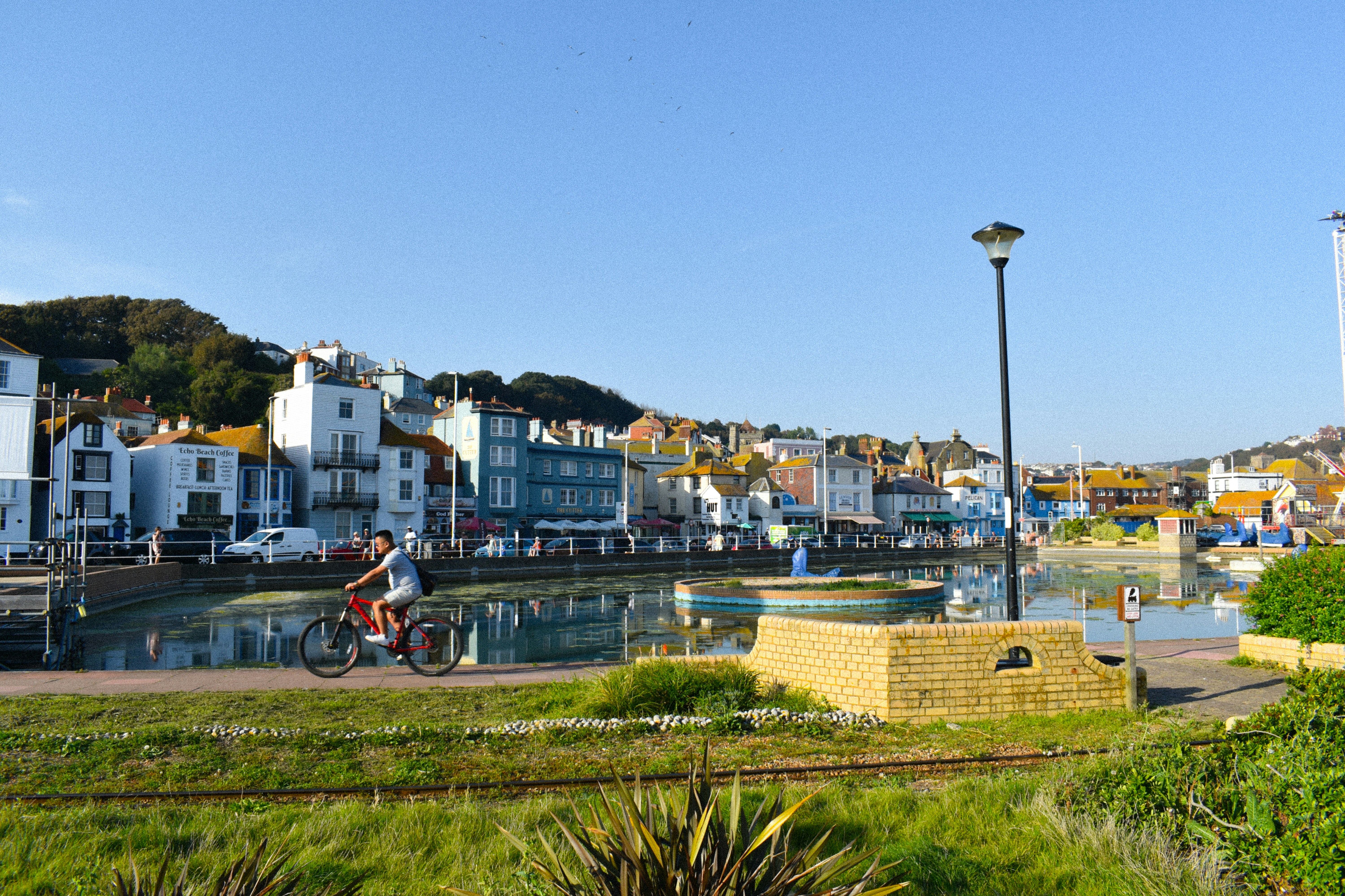 una persona in sella a una bicicletta vicino a uno specchio d'acqua
