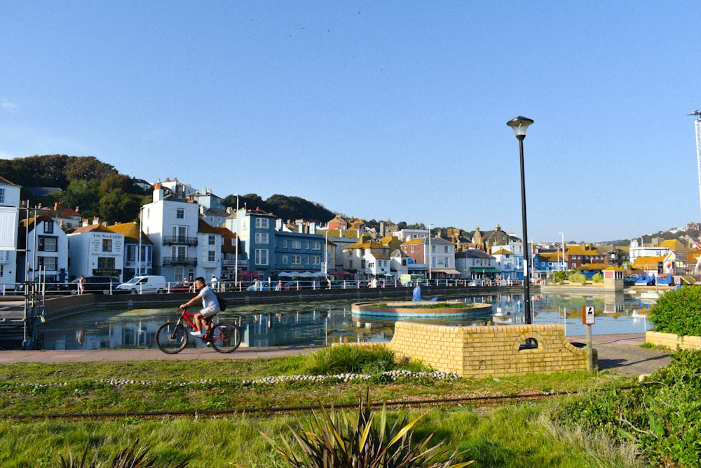 a person riding a bike near a body of water