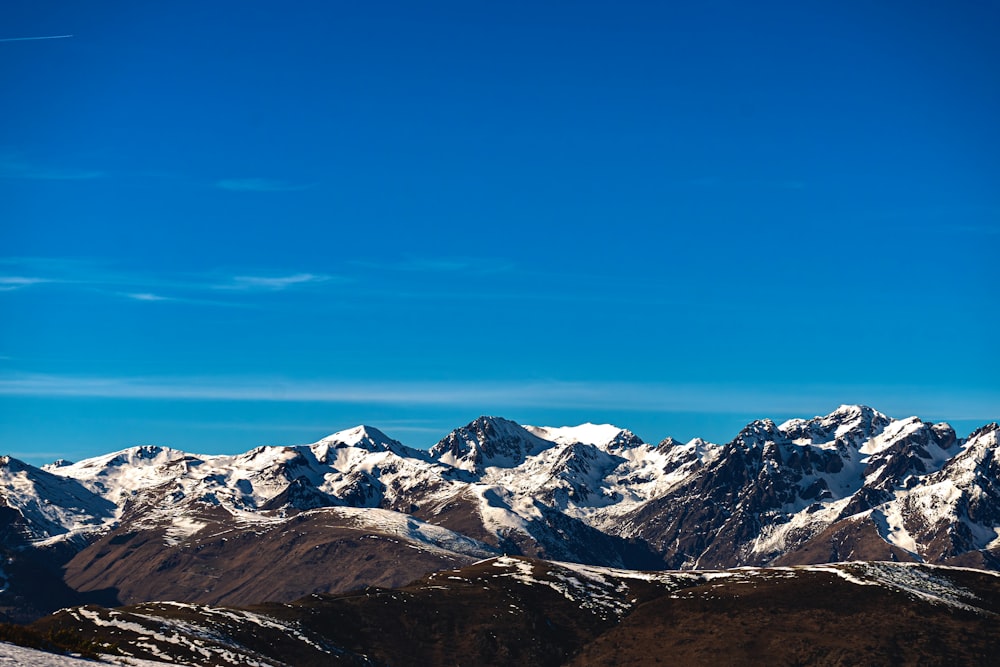 a snowboarder is standing on a snow covered mountain