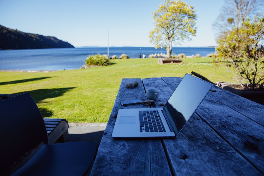 a laptop computer sitting on top of a wooden table