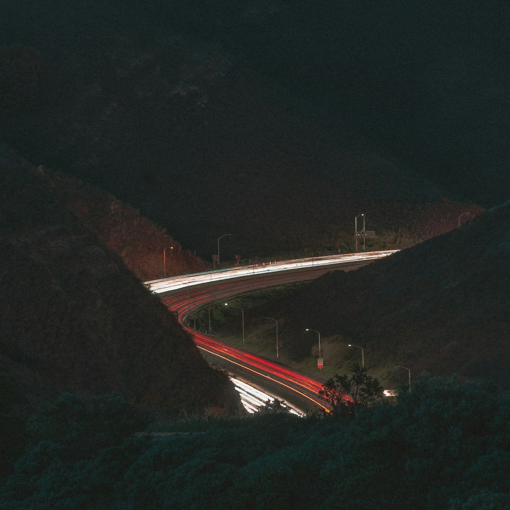 a long exposure photo of a highway at night