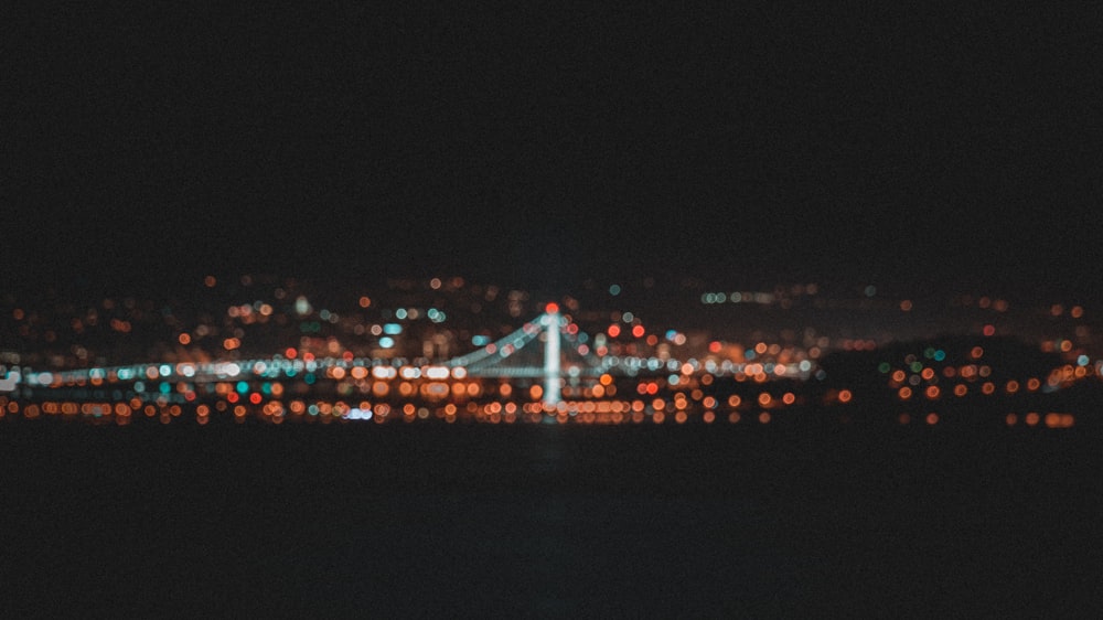a blurry photo of a bridge at night