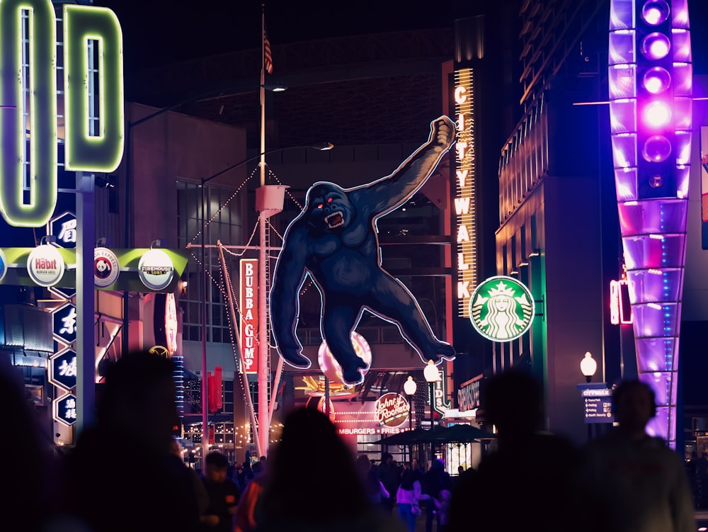 a giant blue gorilla statue in the middle of a busy street