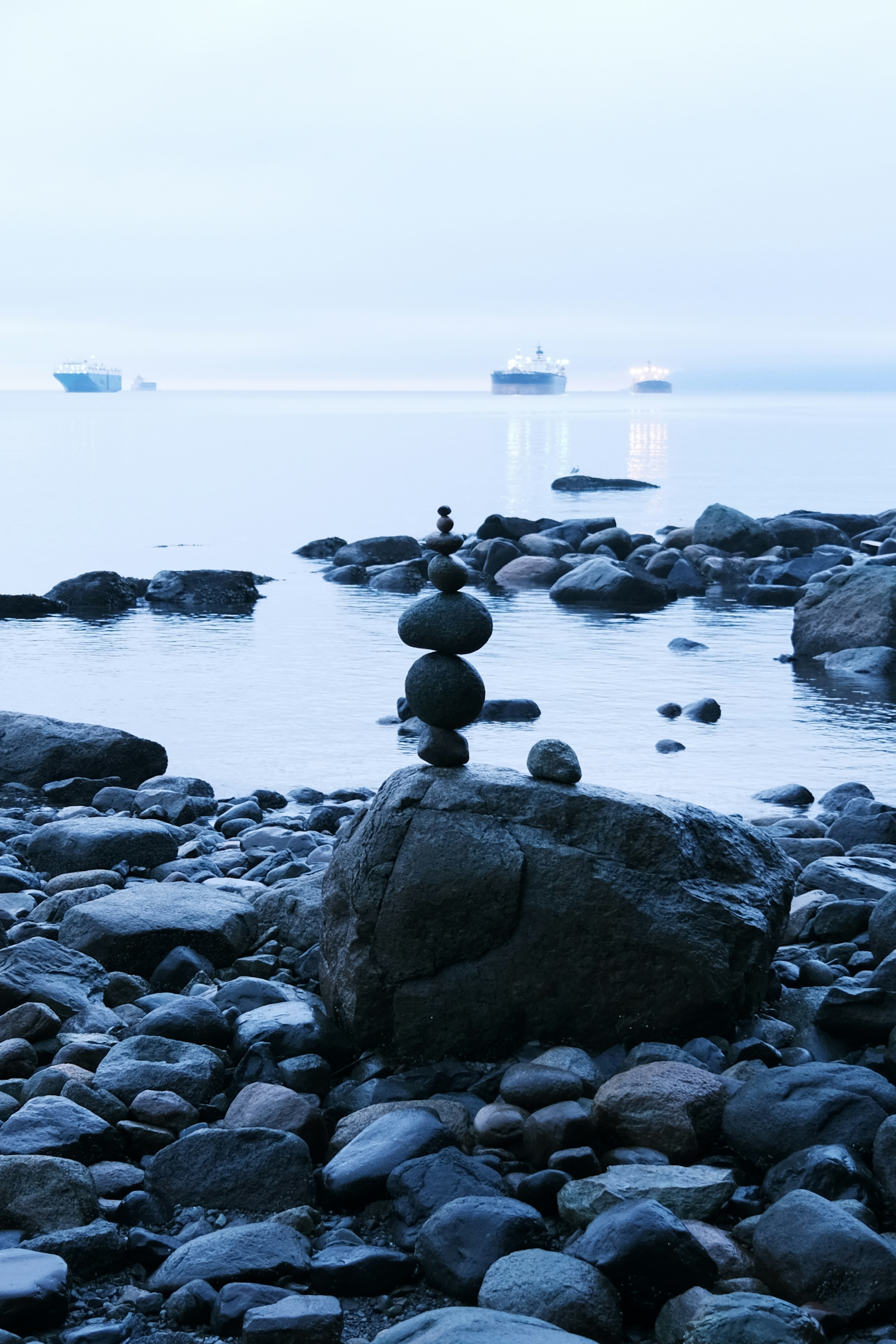 a stack of rocks sitting on top of a rocky beach