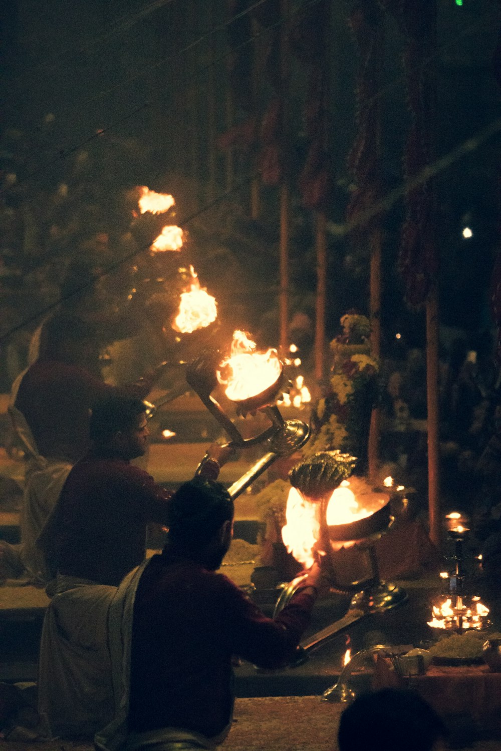 a group of people sitting around a fire pit