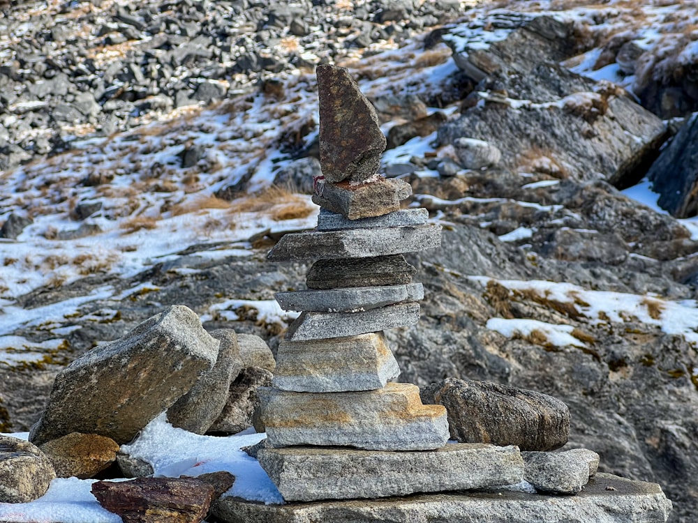 a pile of rocks sitting on top of a snow covered ground