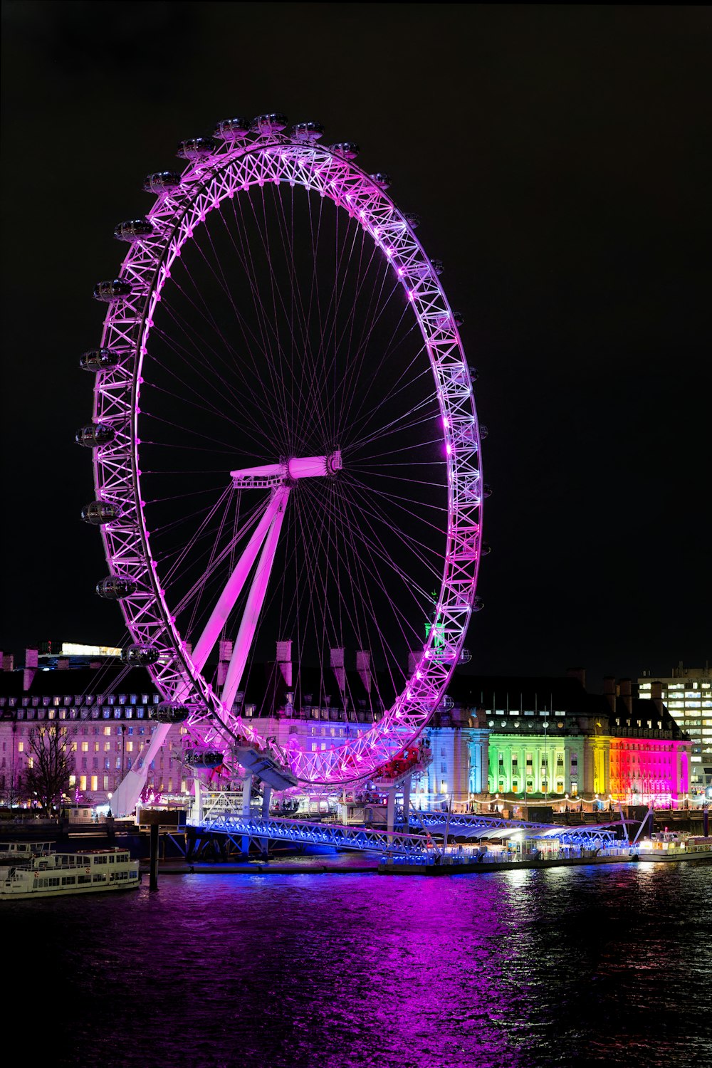 a ferris wheel lit up in the night sky