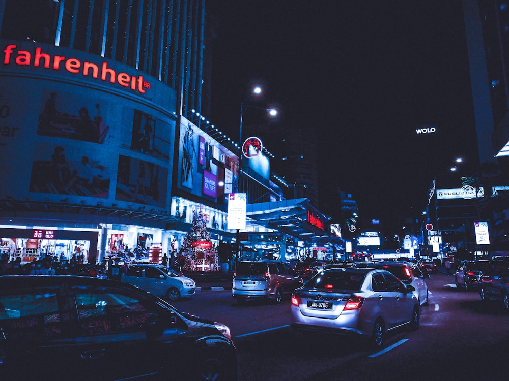 a city street filled with lots of traffic at night