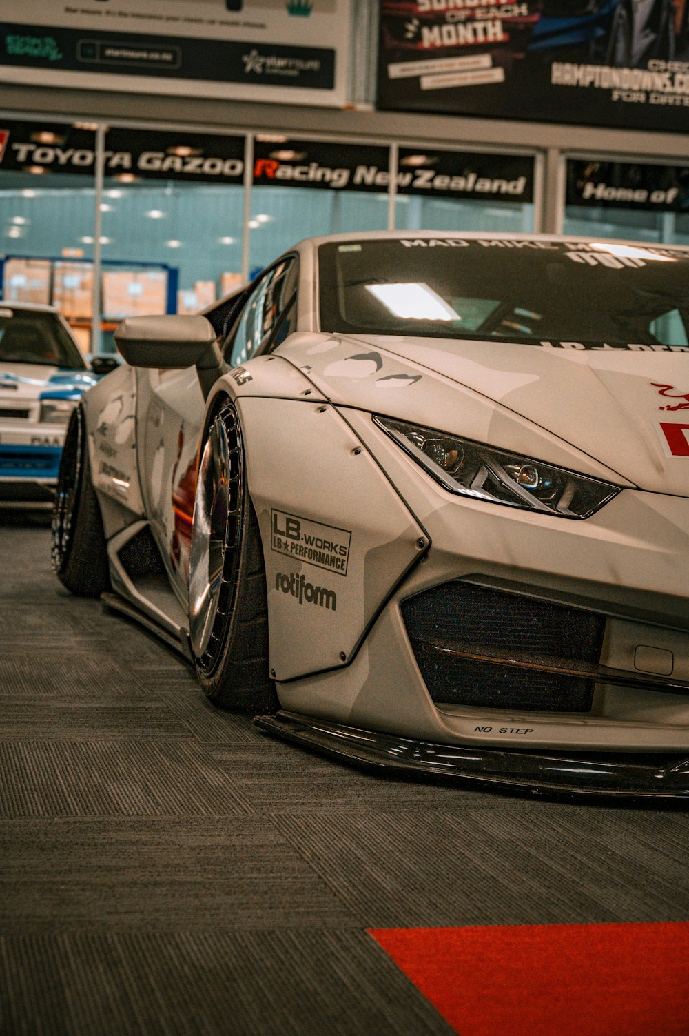 a white sports car parked in a garage