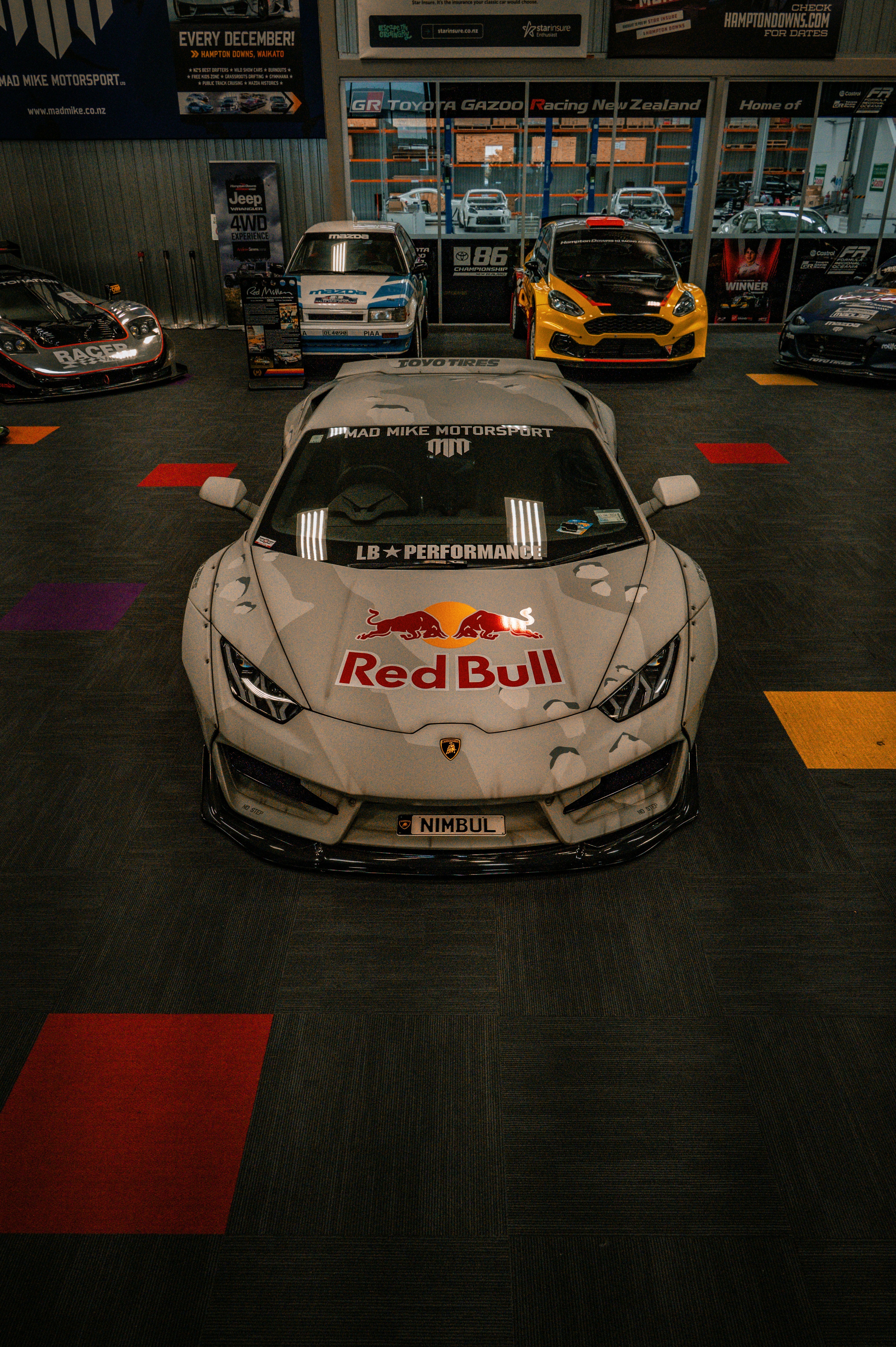 a red bull racing car parked in a garage