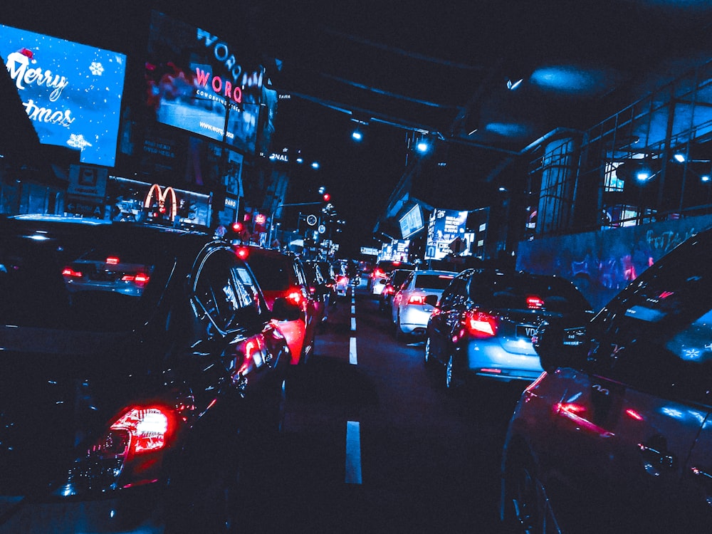 a city street filled with lots of traffic at night