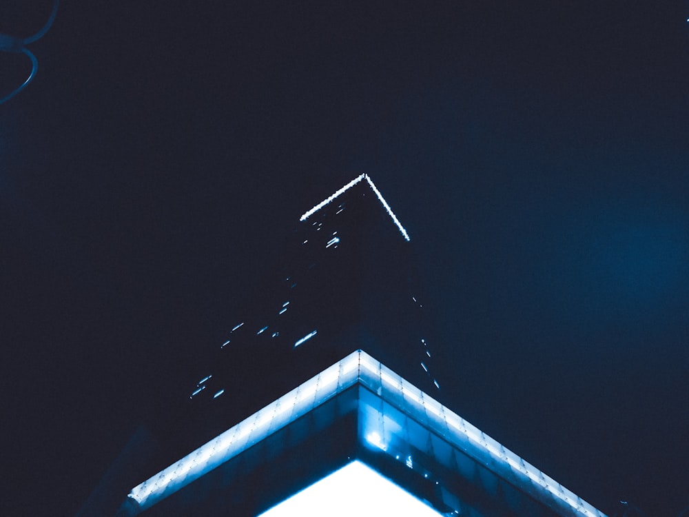 the top of a building lit up at night