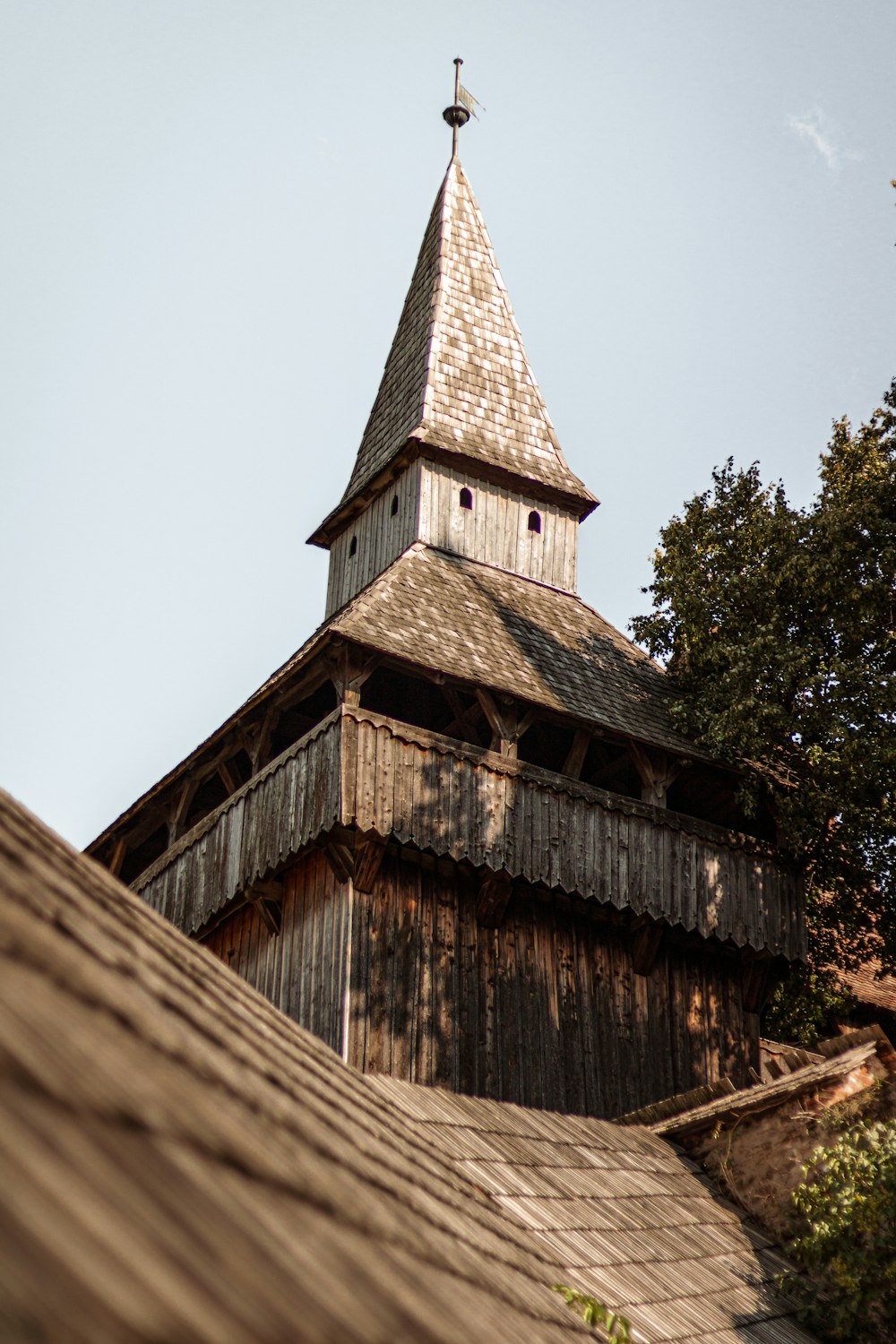 a wooden building with a steeple and a cross on top