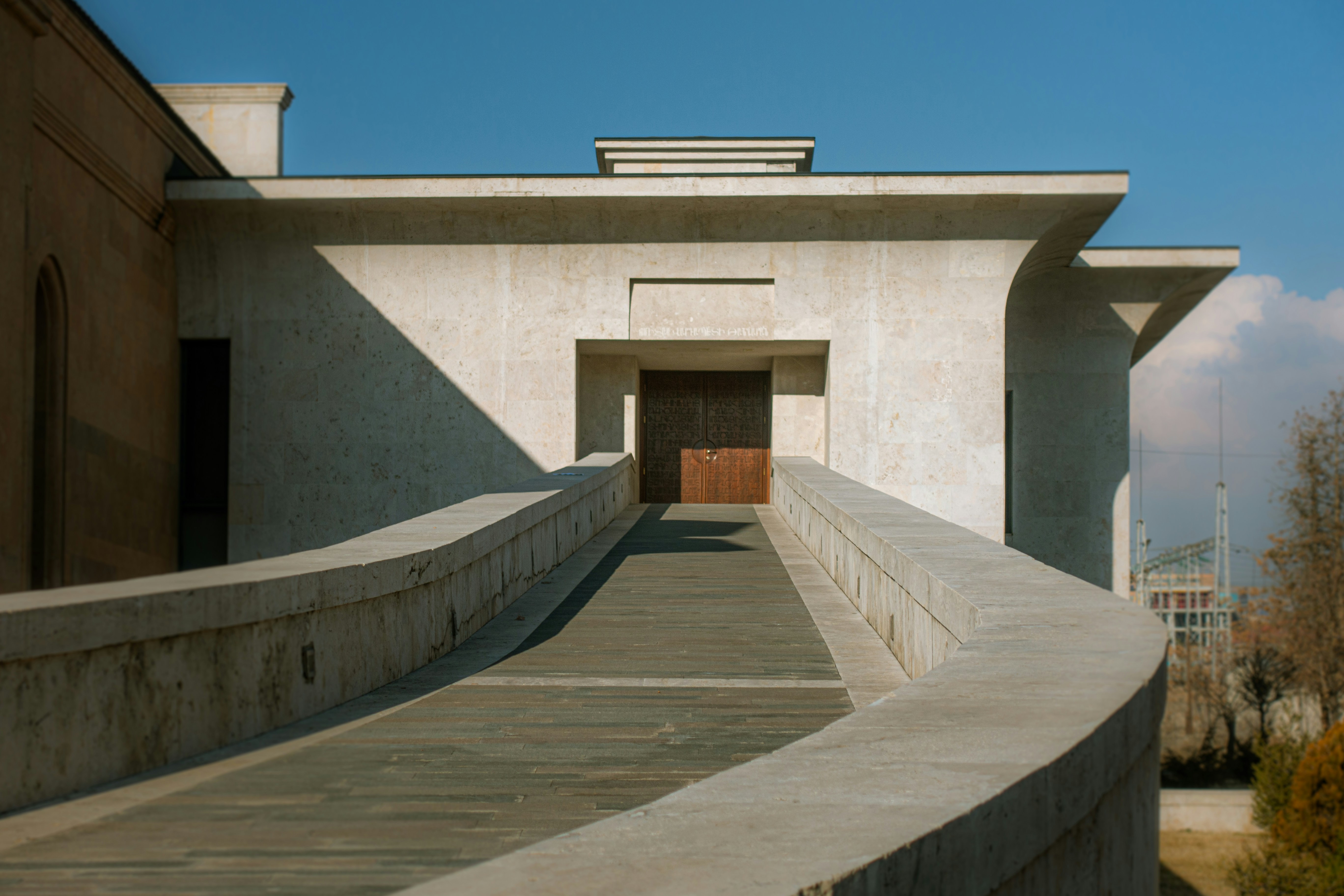 a concrete building with a ramp leading to a door, 