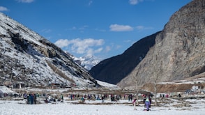 a group of people standing on top of a snow covered slope