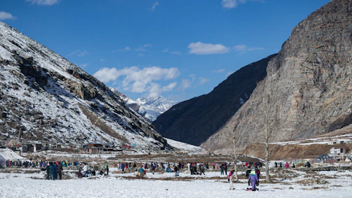 a group of people standing on top of a snow covered slope