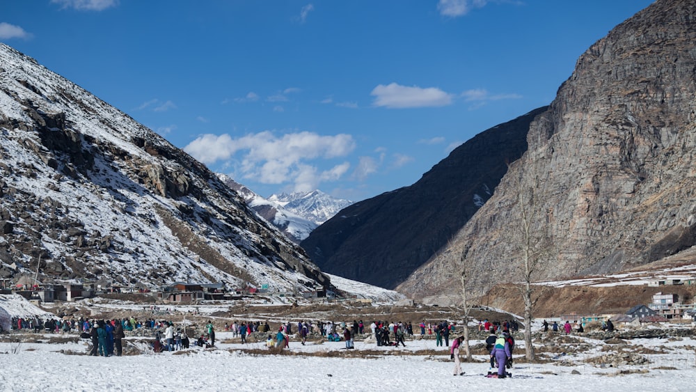 a group of people standing on top of a snow covered slope