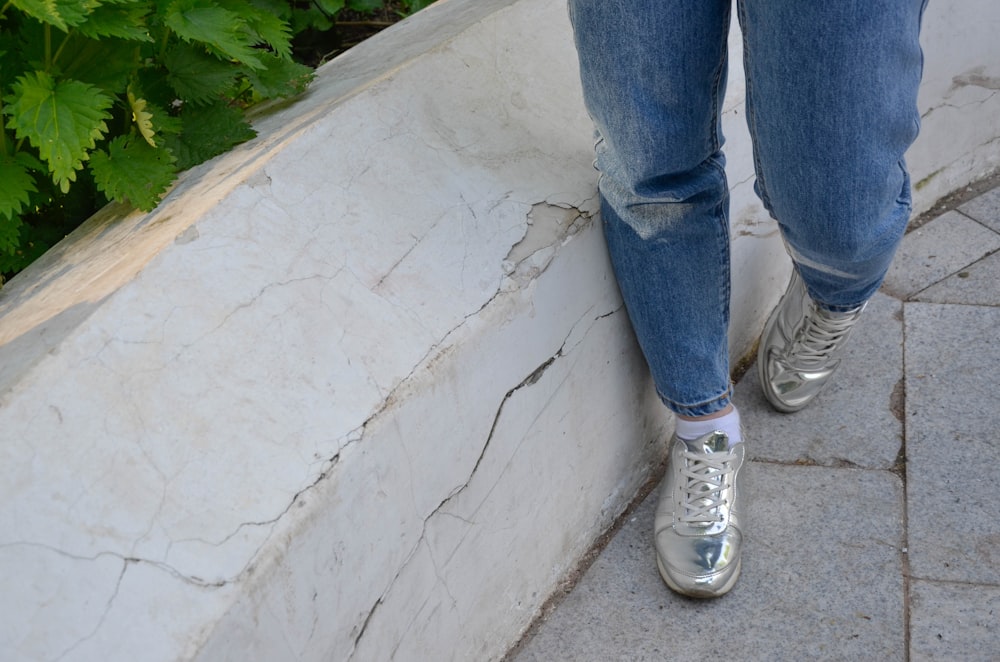 a person standing on a ledge next to a planter