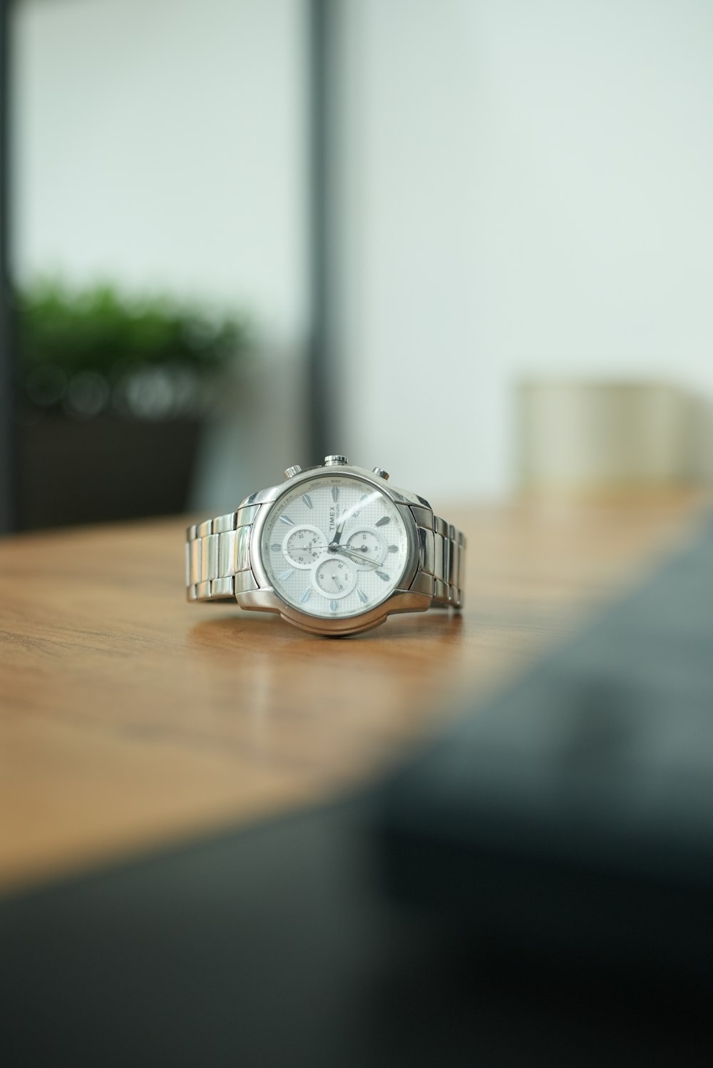 a watch sitting on top of a wooden table