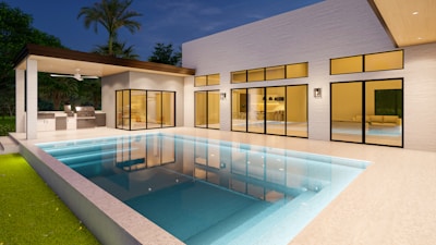 a modern house with a swimming pool at night