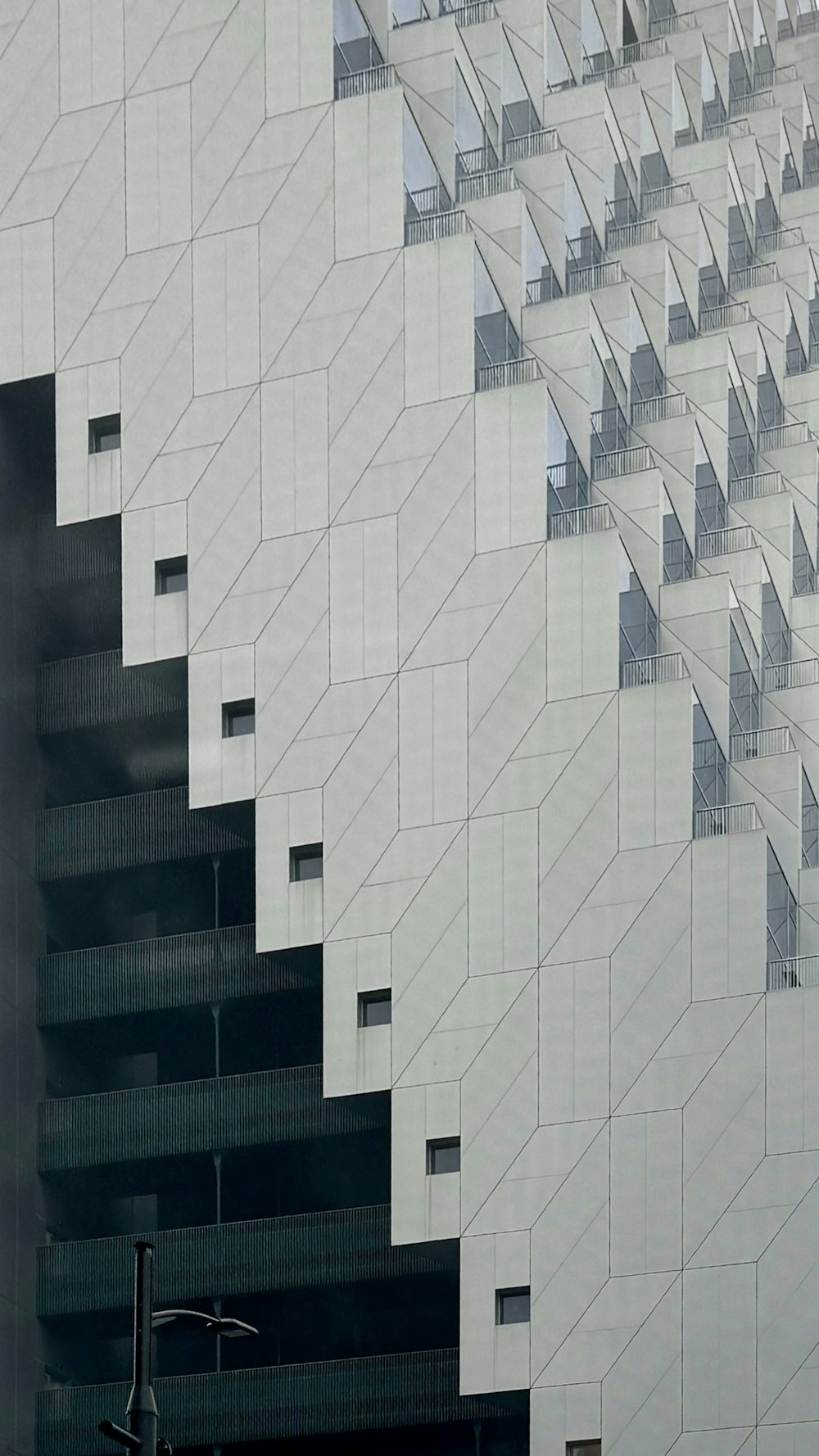 an airplane is flying in the air near a building