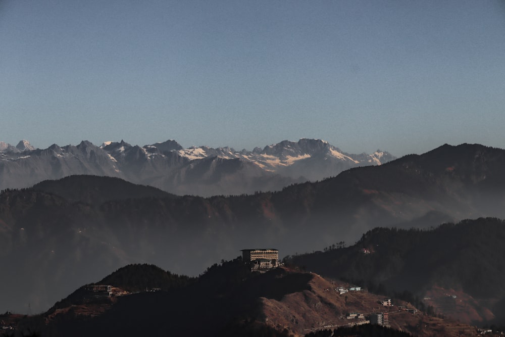 a view of a mountain range with a house on top