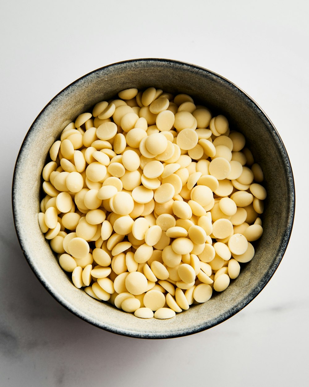 a bowl filled with white beans on top of a table