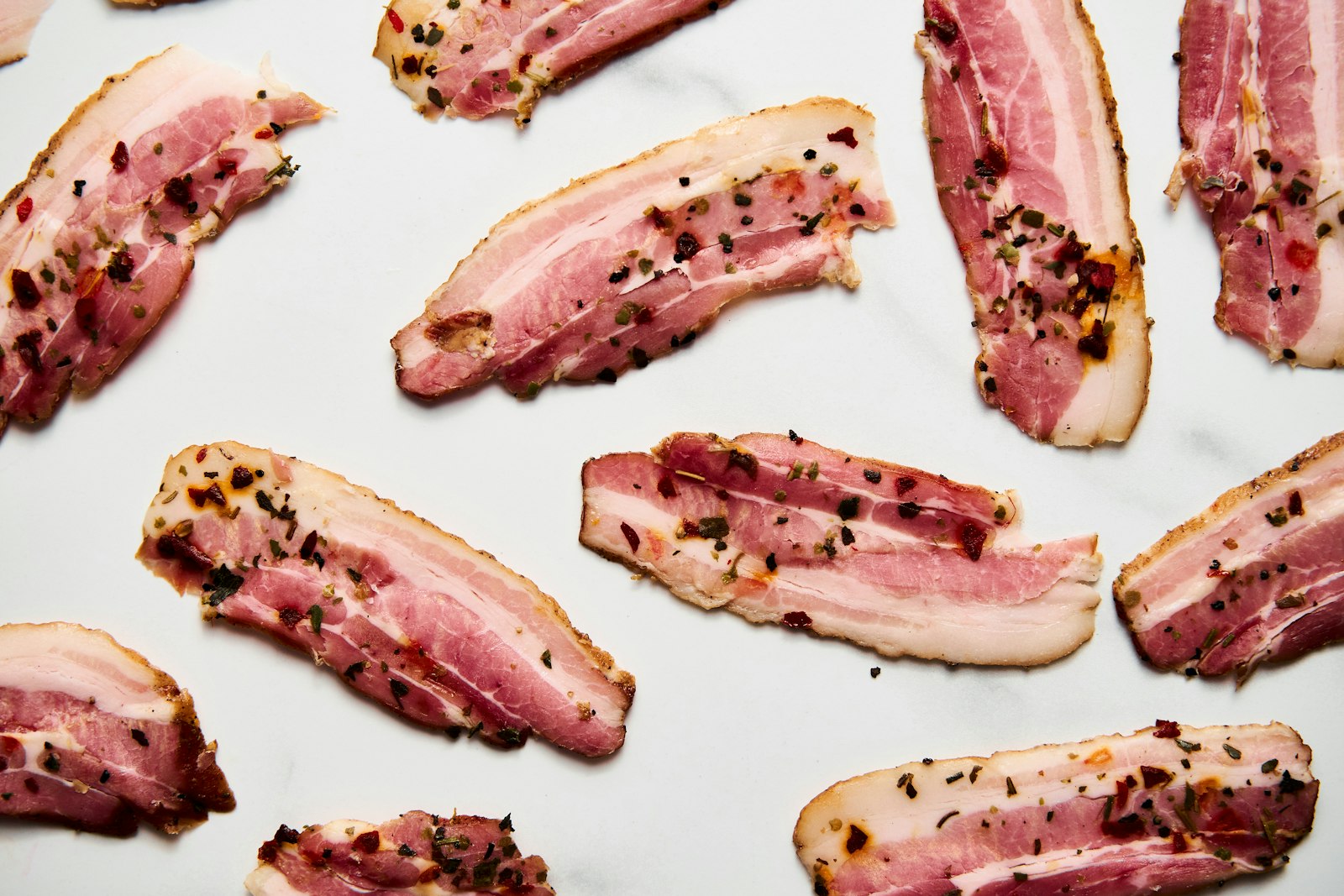 Bacon slices arranged on a light background