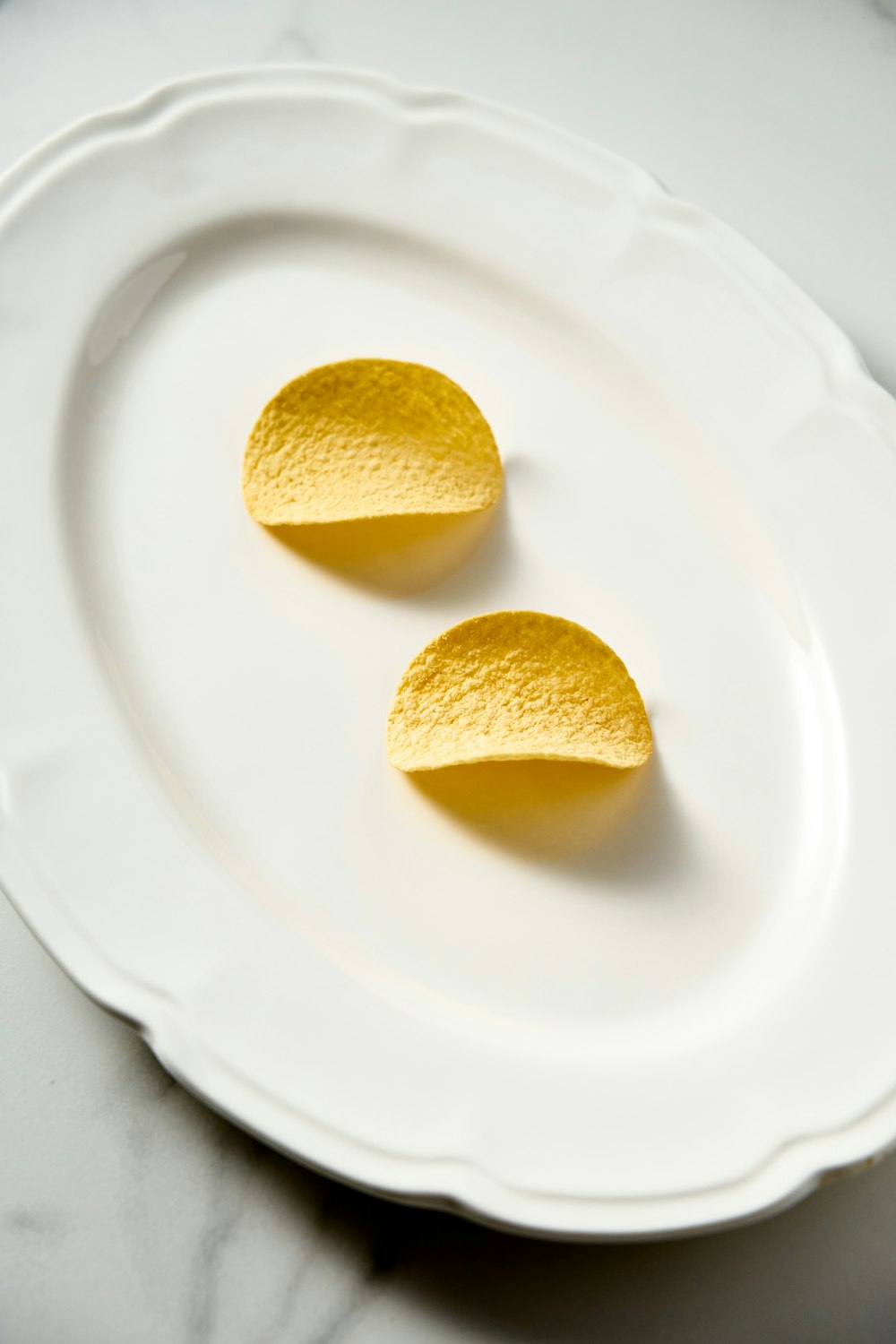 two pieces of lemon on a white plate