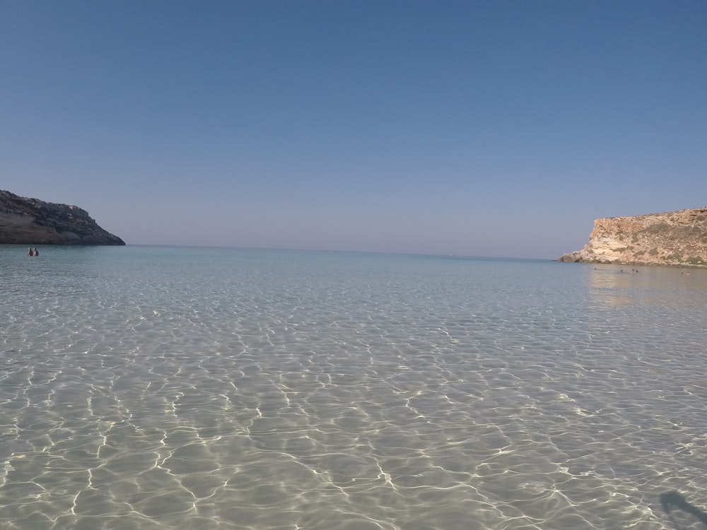 a body of water that has some rocks in it