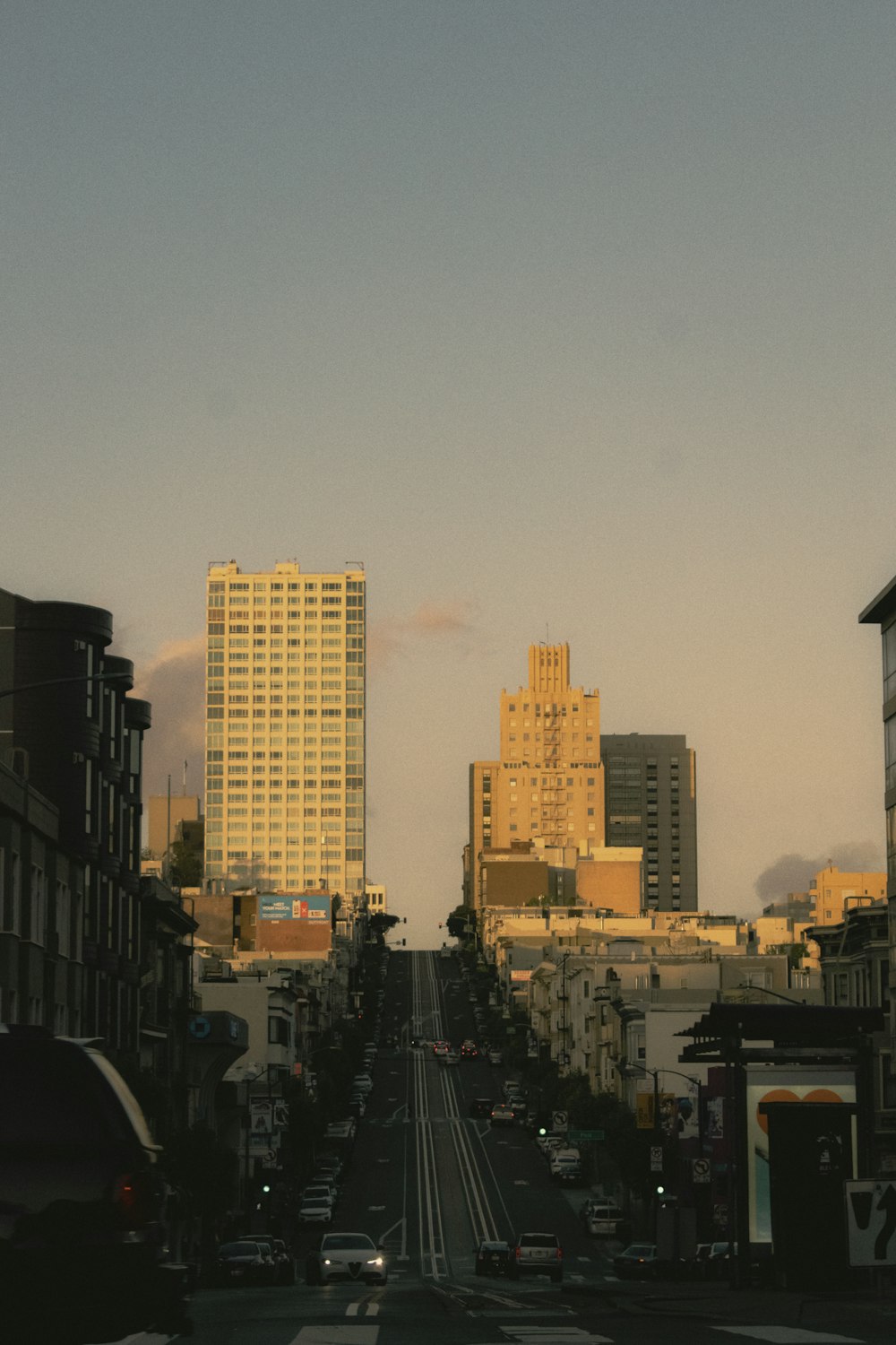 a view of a city street with tall buildings