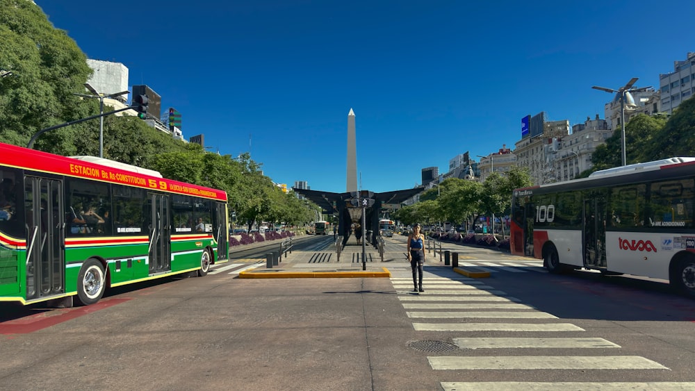 a couple of buses that are sitting in the street