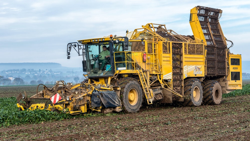 a tractor is plowing a field of crops