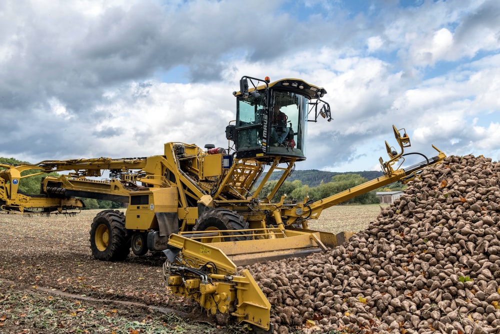 a large load of potatoes being loaded onto a tractor