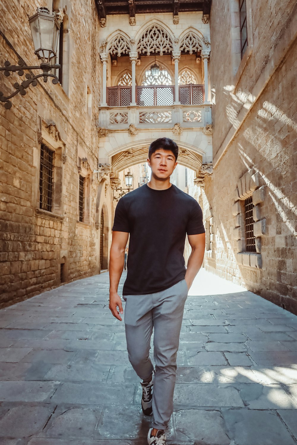 a man walking down a street next to a building