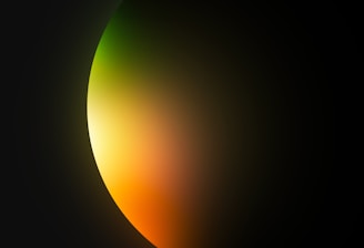 a black background with a yellow and green light