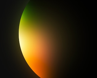 a black background with a yellow and green light