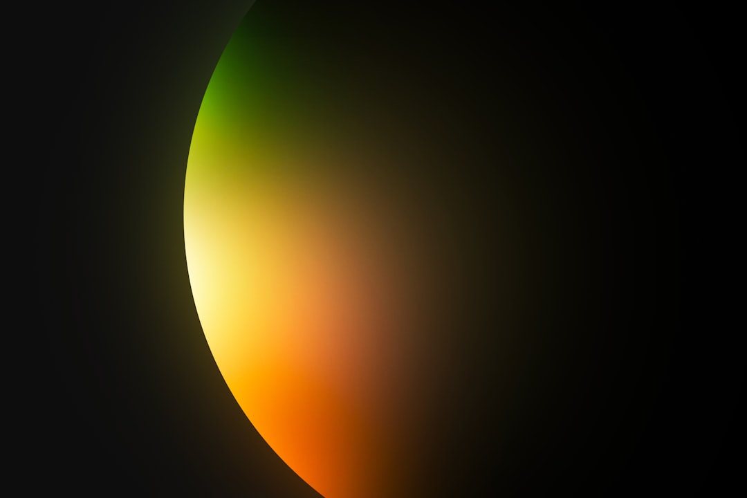 a black background with a yellow and green light, Abstract light leak moving down on blurred background. It