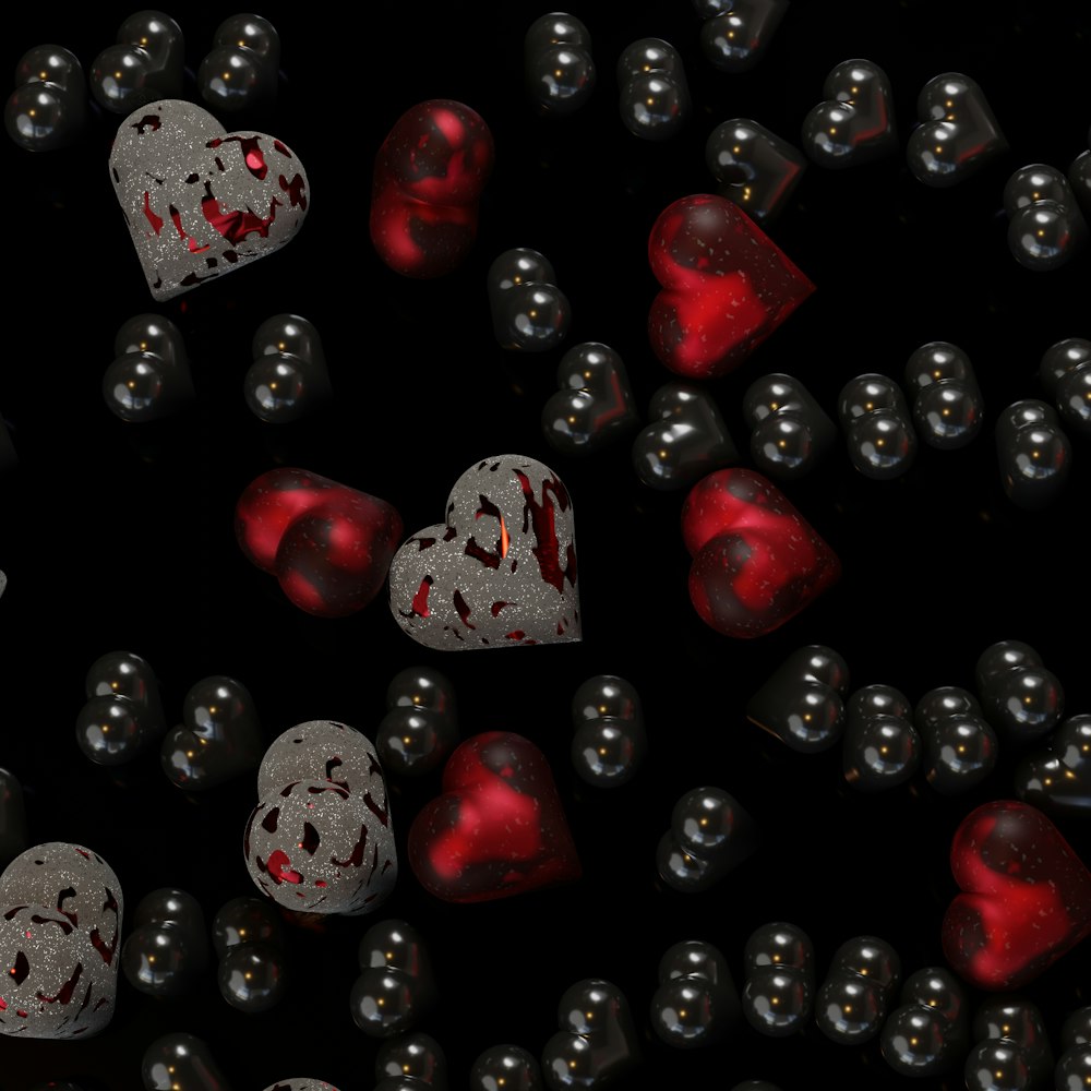 a lot of hearts that are on a black surface