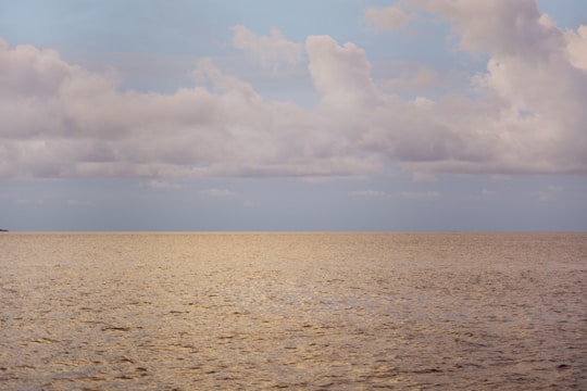 a large body of water under a cloudy sky