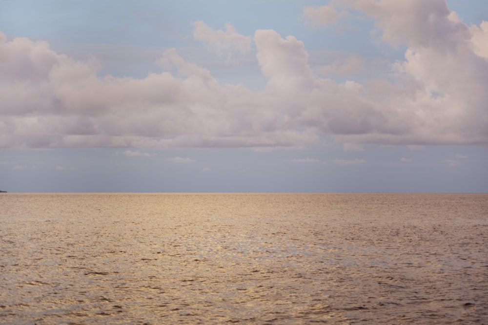 a large body of water under a cloudy sky