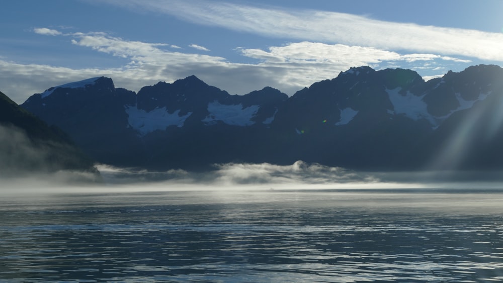 a large body of water with mountains in the background