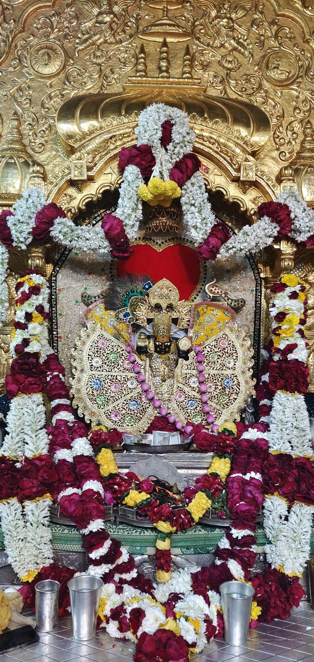 a decorated shrine with a statue and candles