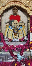 a statue of a god surrounded by flowers