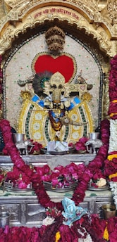 a statue of a god surrounded by flowers
