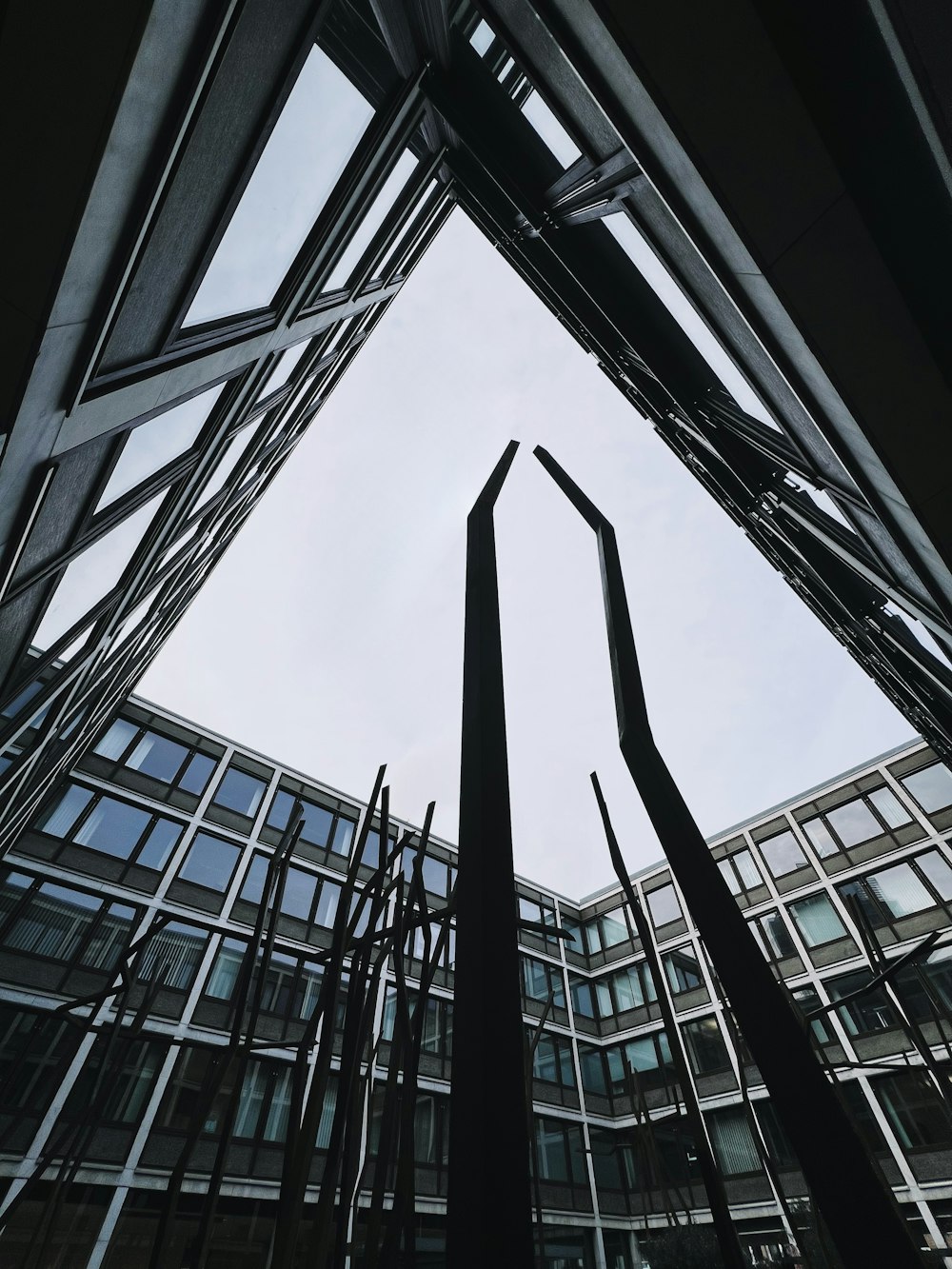 looking up at a sculpture in front of a building