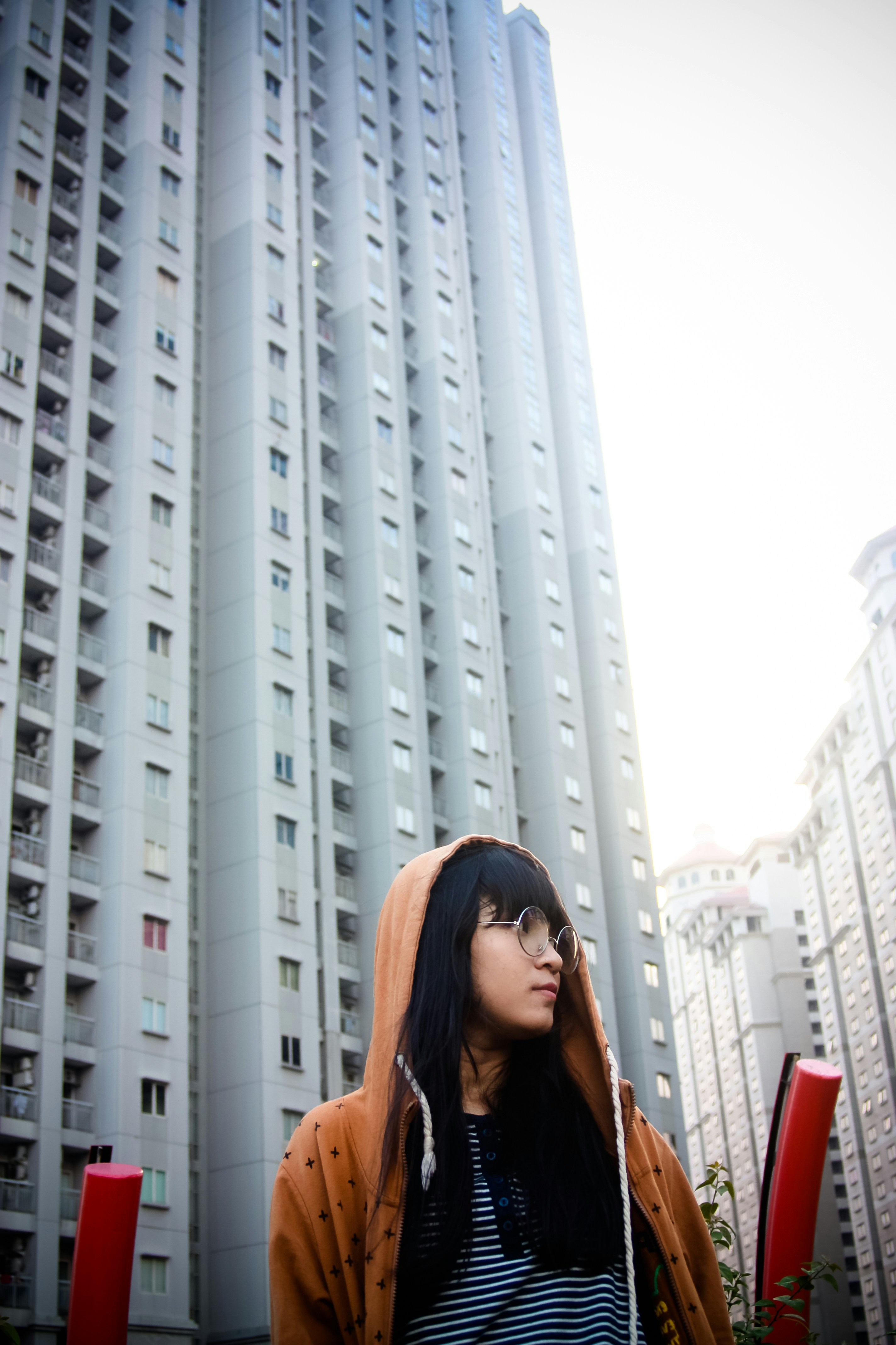 a woman standing in front of a tall building