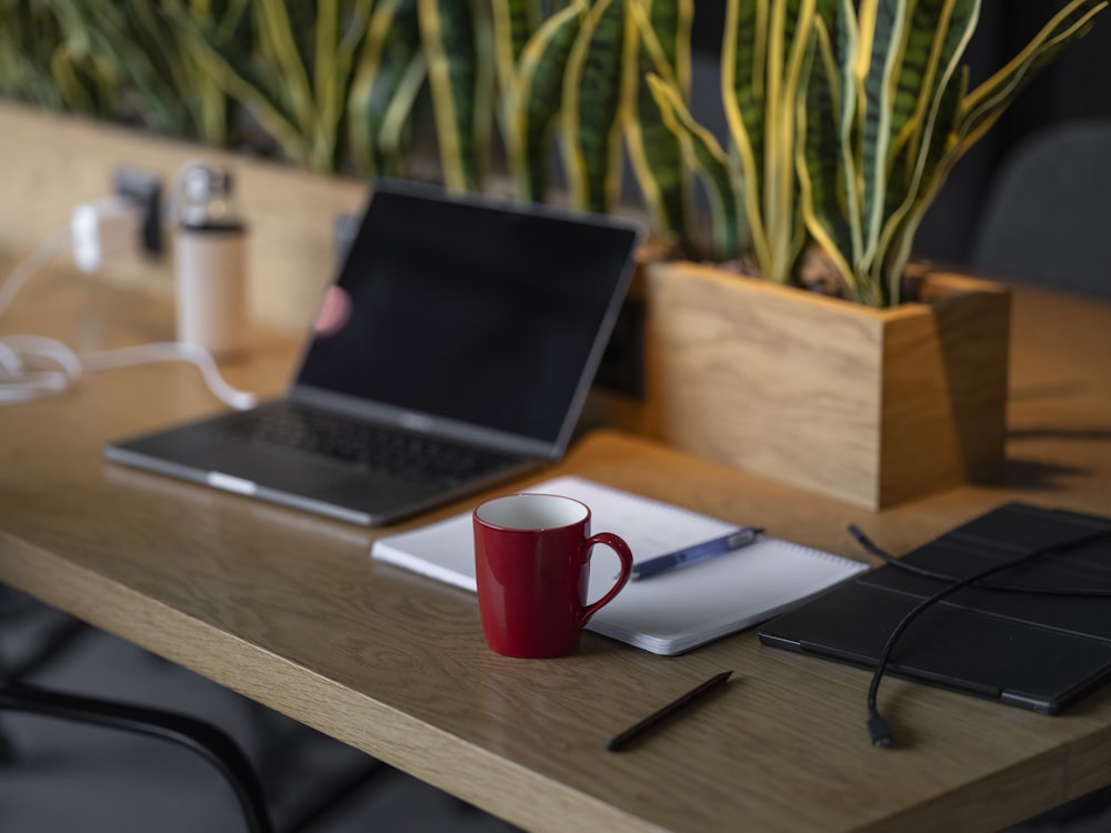 a laptop computer sitting on top of a wooden desk