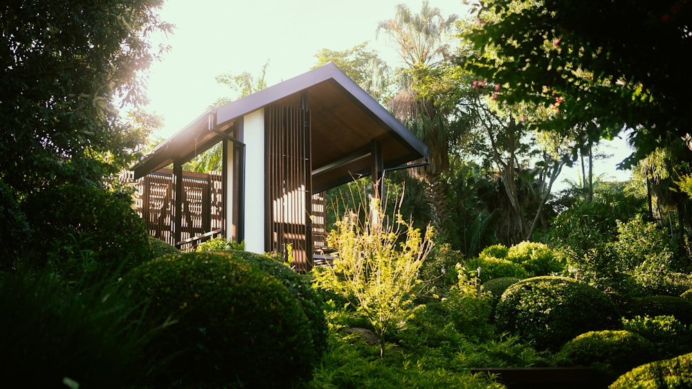 a small wooden structure in the middle of a forest