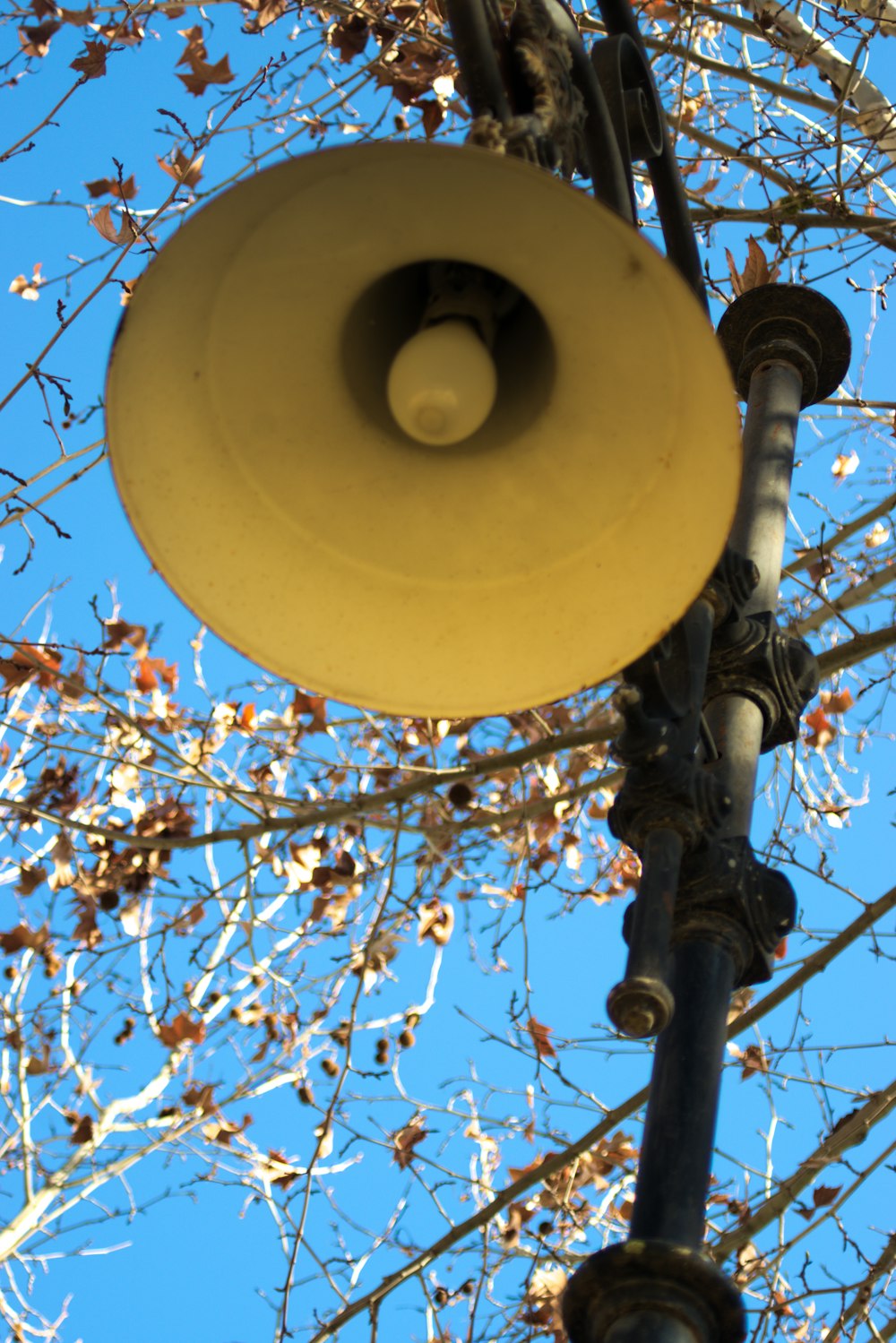 a street light hanging from a metal pole